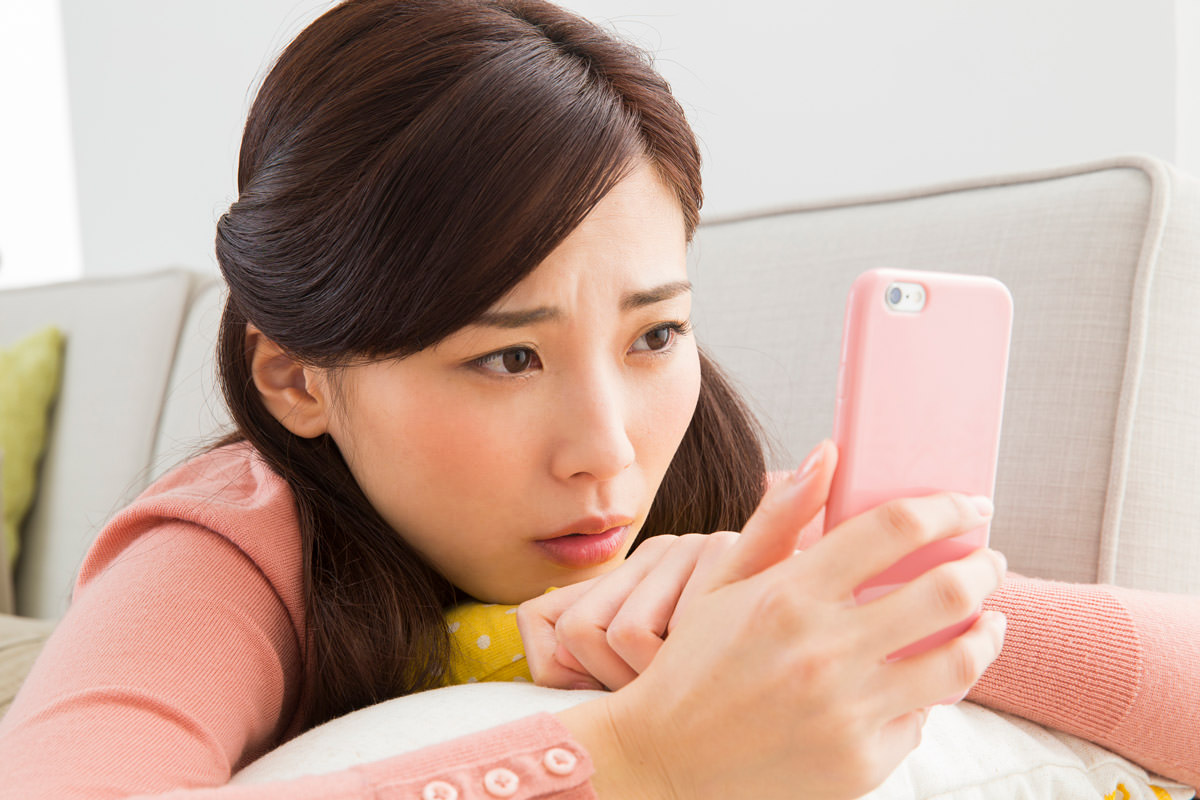 iPhoneの誤動作で困っている女性のイメージ写真