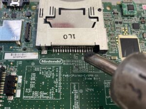 ヒートガンを使用してカードスロットを基板に実装する作業。