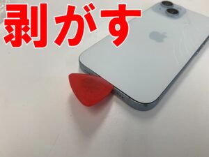 割れた背面ガラスを本体フレームから剥がしているiPhone15